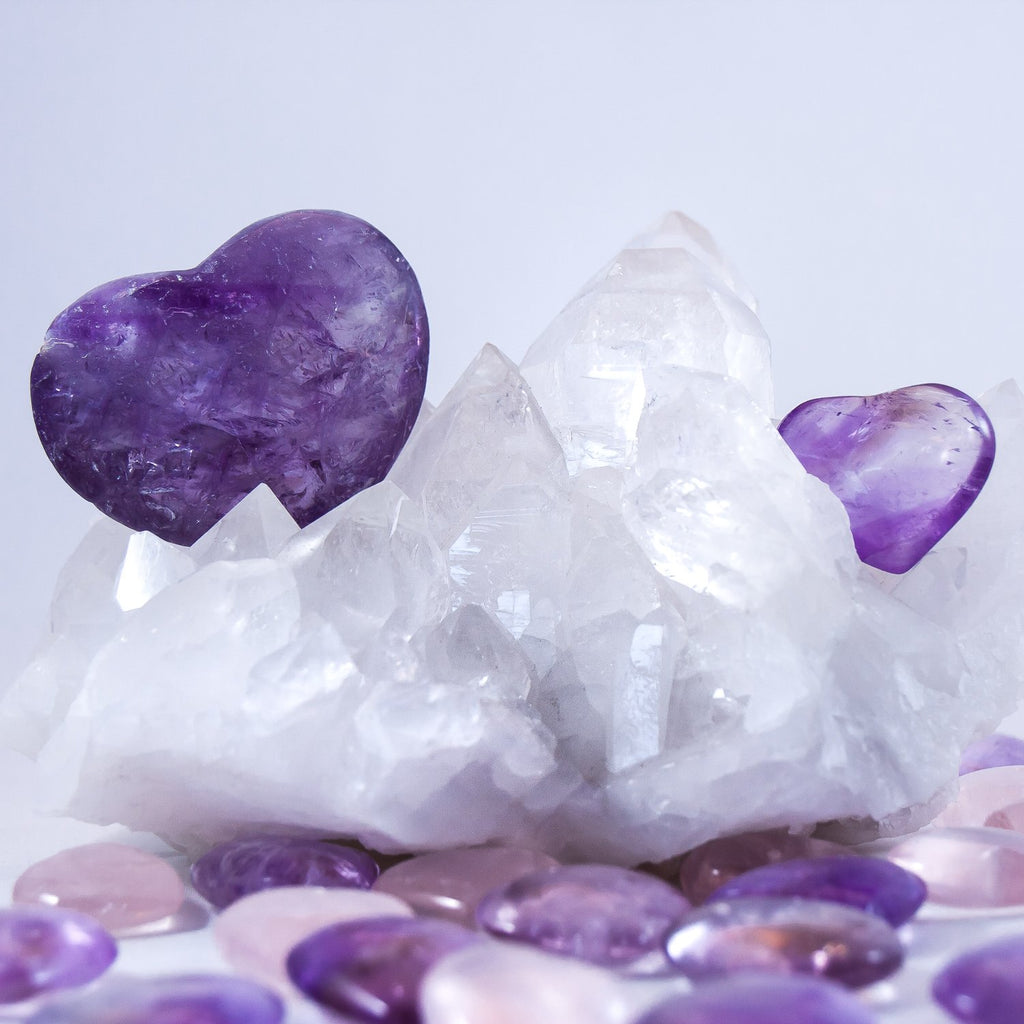 small and large amethyst high frequency crystal hearts. large is amethyst and small are ametrine.