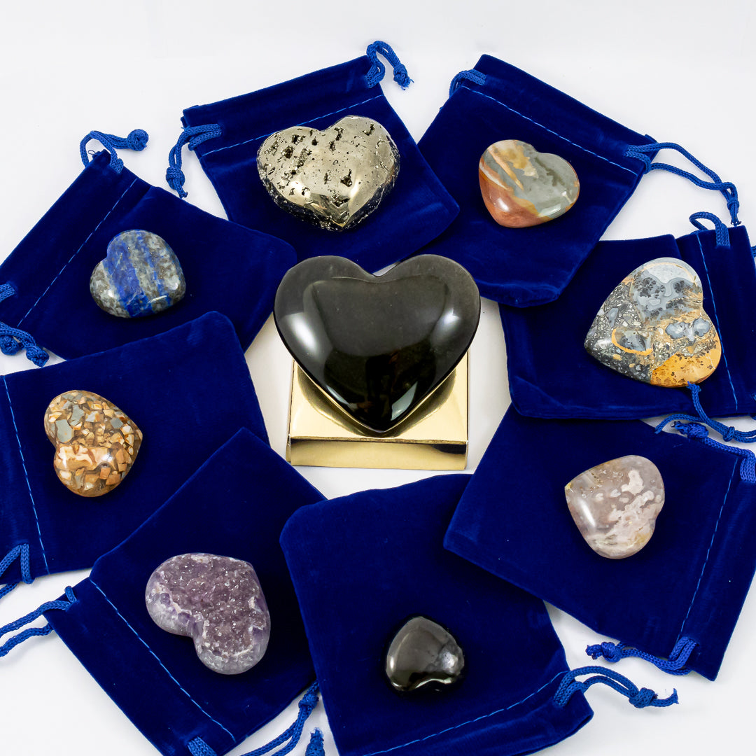 gifts from my heart crystal set (with blue velvet bags) close-up. amethyst crystal druzy heart, flower agate crystal heart, lapis lazuli crystal heart, polychrome jasper crystal heart, pyrite crystal heart , sheen obsidian crystal heart, shungite crystal heart, maligano jasper crystal heart, ibis jasper crystal heart.