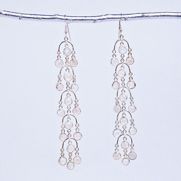 moonstone goddess chandelier earrings set in sterling silver and with sterling silver ear wires. hung on silver branch for aesthetics.