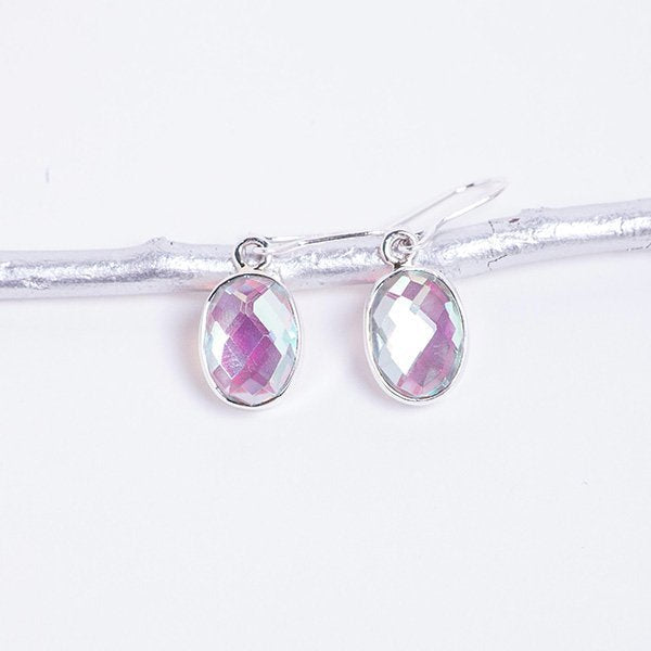 mystic topaz crystal oval earrings set in sterling silver. hanging on silver branch.