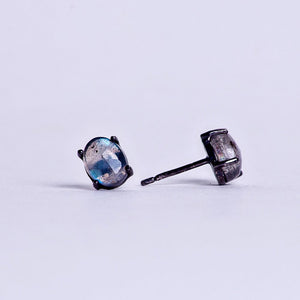 Open image in slideshow, labradorite crystal oval antiqued earrings on black rhodium plated sterling silver posts. side view.
