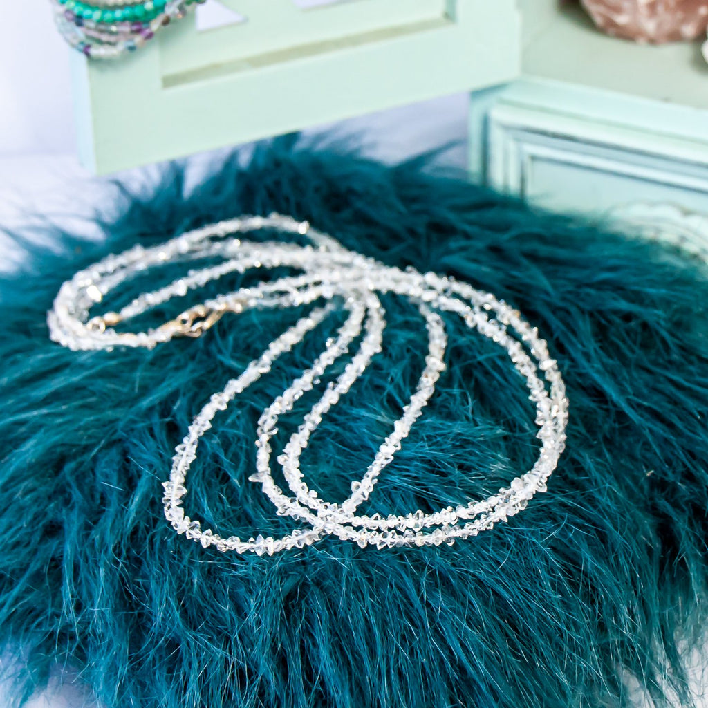 2-3mm herkimer diamond beaded necklace on turquoise furry pillow.