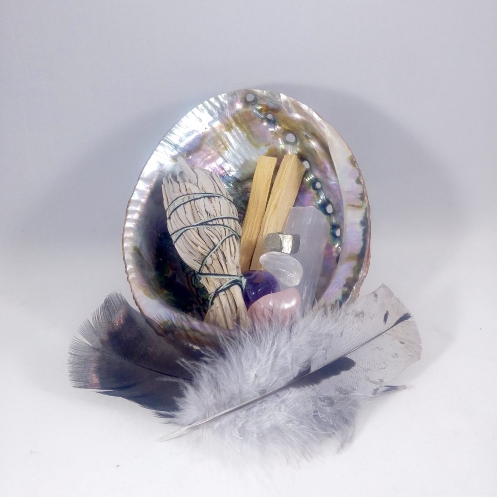 smudge essentials cleansing kit includes: abalone, white sage smudge, palo santo, black turkey feather-cruelty free, blue slate turkey feather -cruelty free (choose one feather), tumbled stones-rose quartz, amethyst, pyrite, clear quartz.