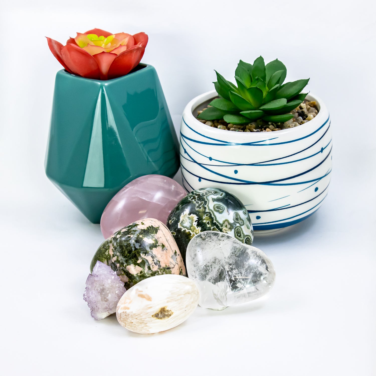 inner peace crystal set. clear quartz heart; ocean jasper, rose quartz, and unakite polished stones; peach scolecite palm stone; and spirit quartz crystal cluster.