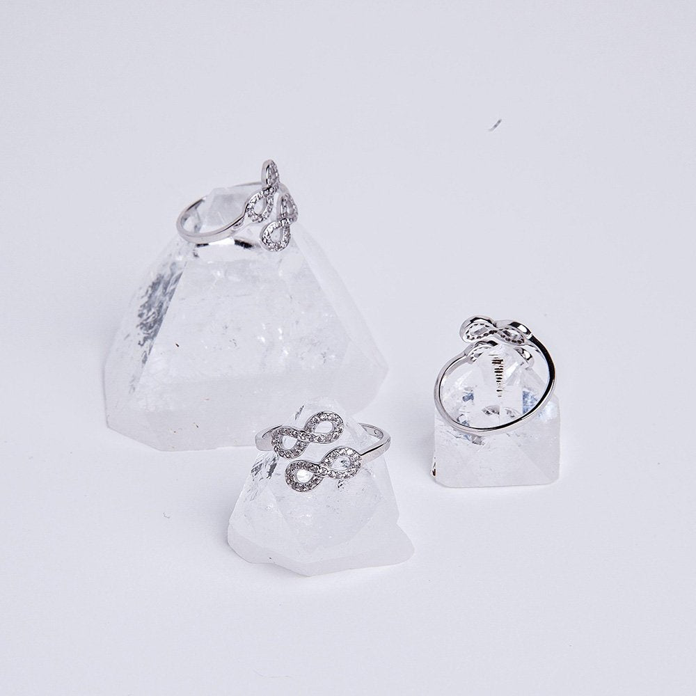 Double infinity sparkle rings sitting on apophyllite crystals.
