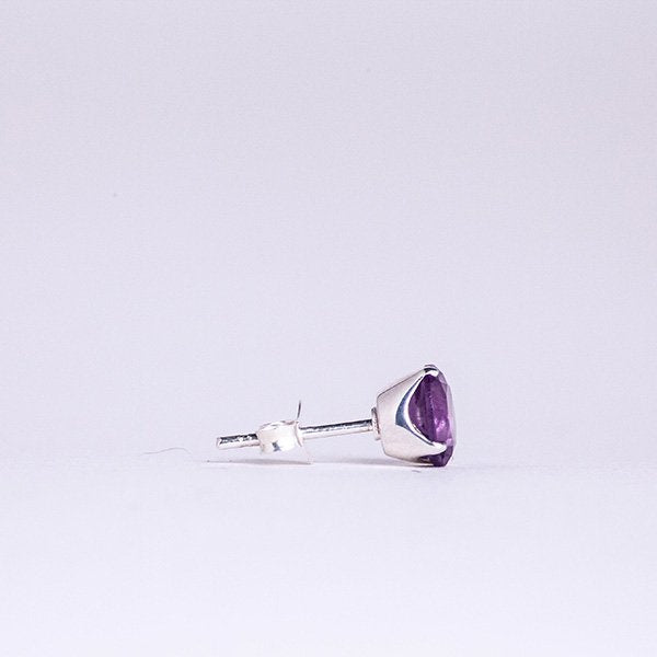 side view of amethyst round faceted crystal earrings set in a sterling silver post.